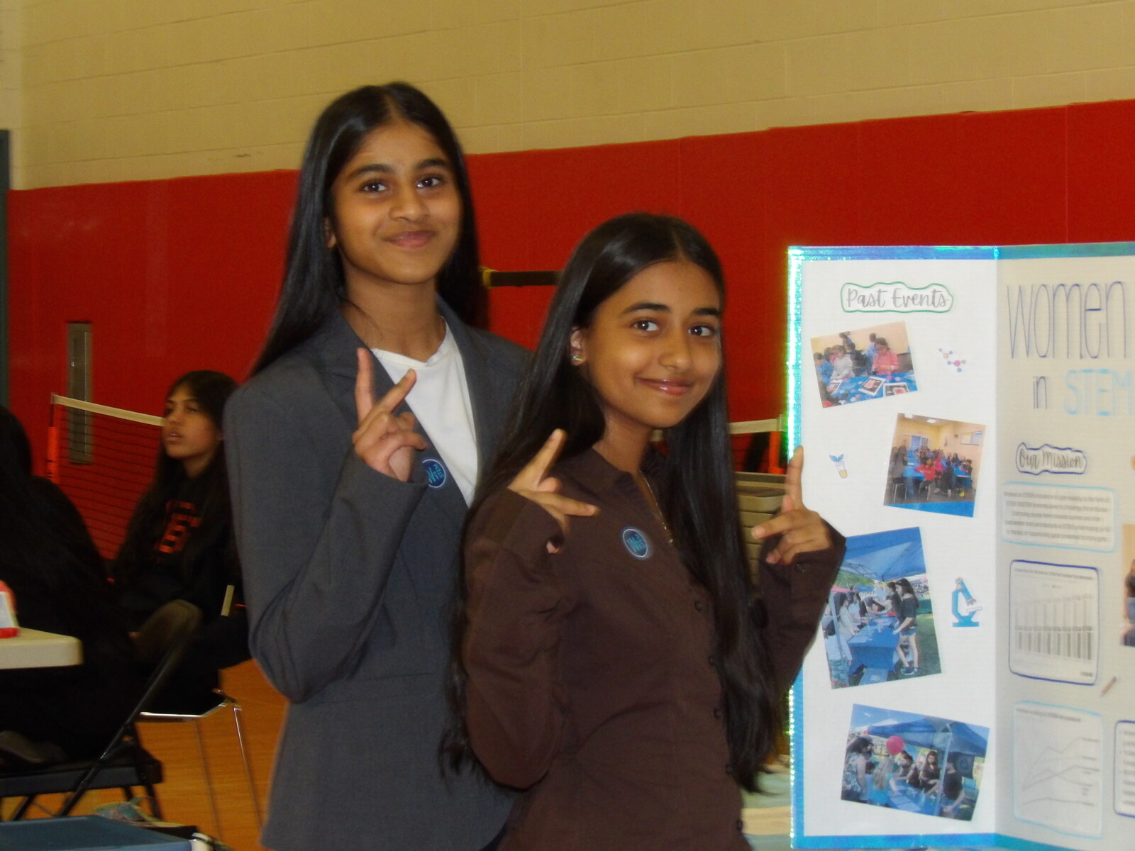 Two students at the Women in STEM nonprofit booth.