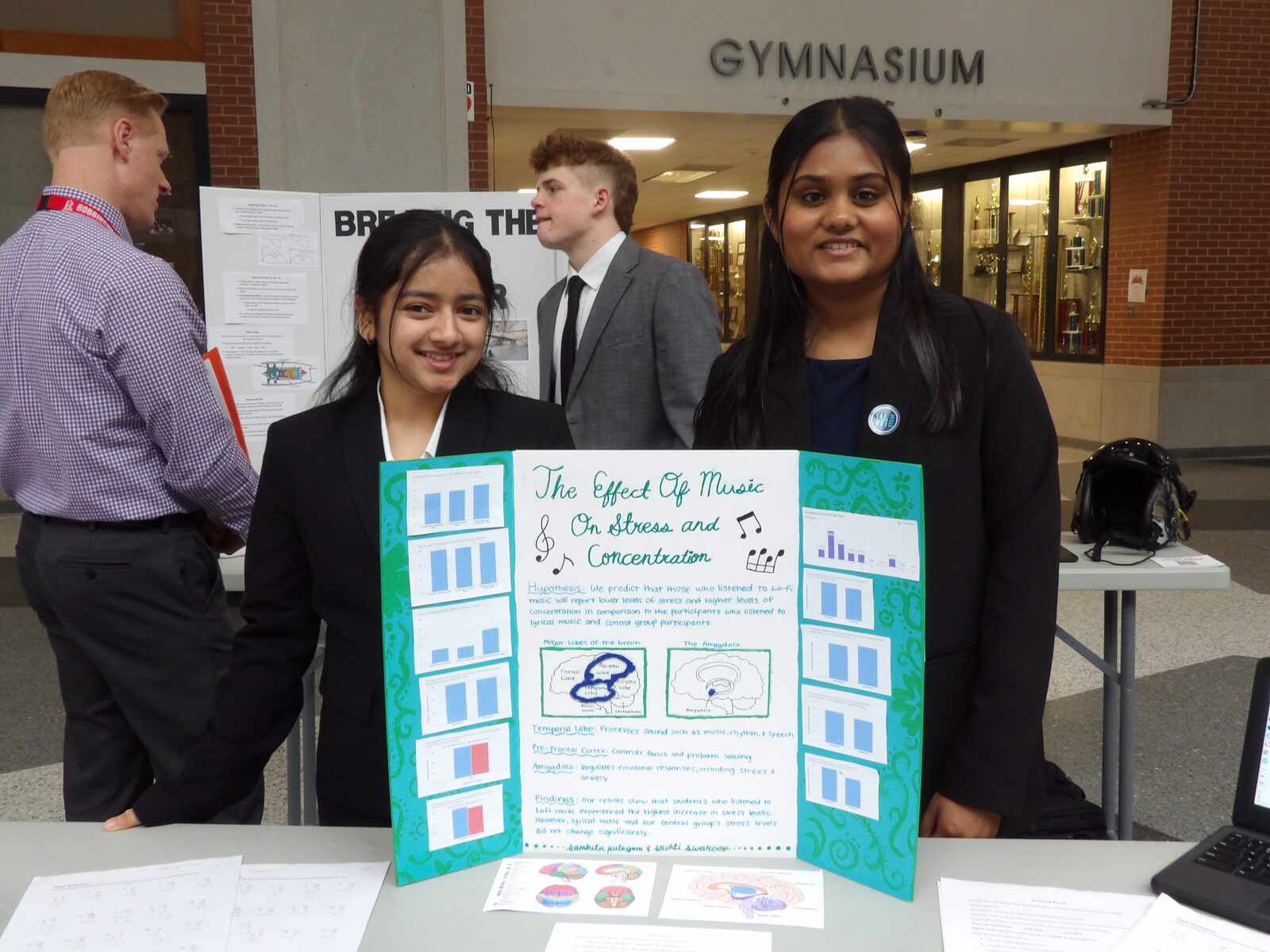 SciFest 2026 presenters beside their research board.